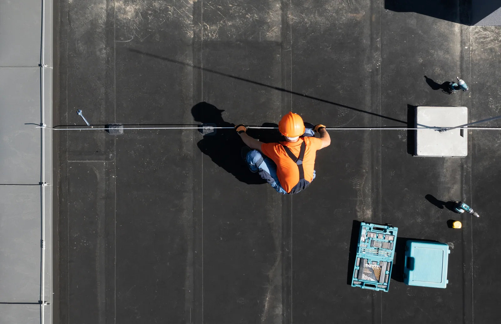 Roofer checking a commercial roof in Newport News, VA